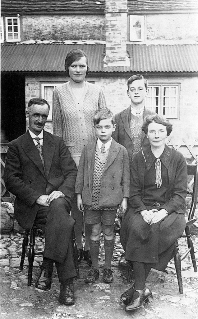 Photograph of Tom & Ada Barnes (seated) with Ena, Jim and Bob in a back garden